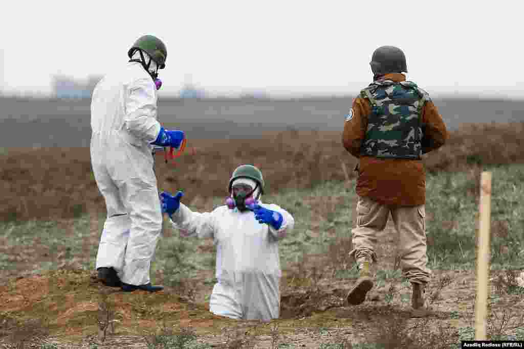 Azerbaijani mine-clearance officers prepare to detonate unexploded munitions. 
