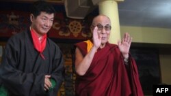 Lobsang Sangay (left) poses with the Dalai Lama after taking the oath of office as the new prime minister of the Tibetan government-in-exile last year.