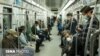 Commuters wearing masks against coronavirus on Tehran underground (metro) on April 7, 2020. 