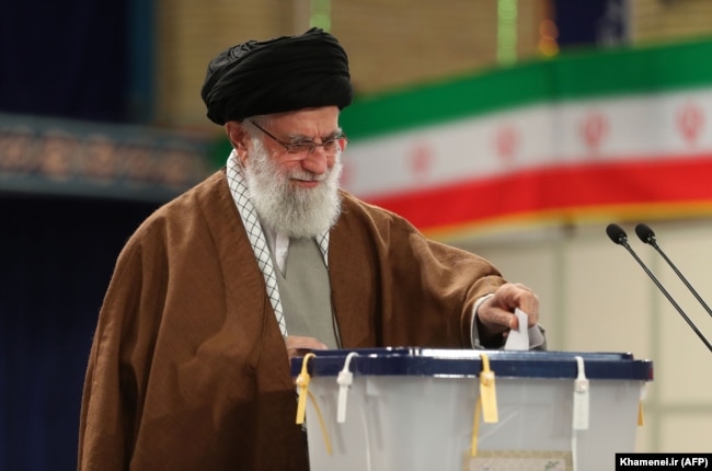 Iranian Supreme Leader Ayatollah Ali Khamenei casts his vote at a polling station in Tehran on February 21.