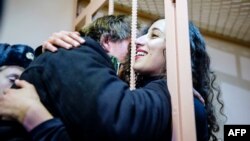 Greenpeace International activist Faiza Oulahsen (right) from the Netherlands celebrates after being granted bail during a hearing on the "Arctic Sunrise" case at Primorskiy Court in St. Petersburg on November 20.