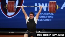 Sohrab Moradi from Iran sets a world record of 233 kilograms during the clean and jerk competition at the Weightlifting World Championships in Anaheim, California, on December 3. 