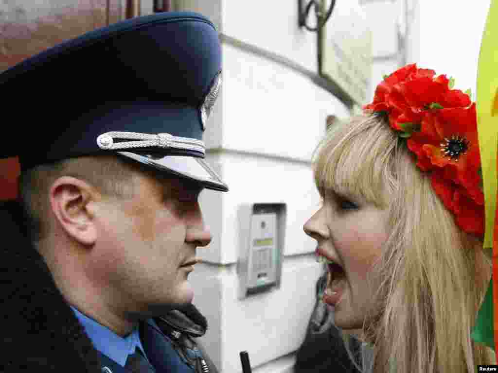 An activist from the women's rights organization Femen shouts at an Interior Ministry officer as she takes part in a rally to support Sakineh Mohammadi Ashtiani, at the Iranian Embassy in Kyiv on November 3. Ashtiani, whose sentence of execution by stoning for adultery provoked a worldwide outcry, will instead be hanged for the murder of her husband.Photo by Konstantin Chernichkin for Reuters