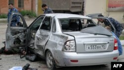 Police and forensic experts investigate the site of a suicide bomb attack in Grozny on August 21.