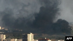 Smoke rises over Gaza City in the second week of the conflict