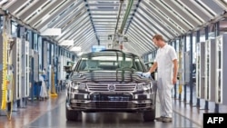 A Volkswagen employee polishes a VW Phaeton car at the company's so-called transparent factory in Dresden.