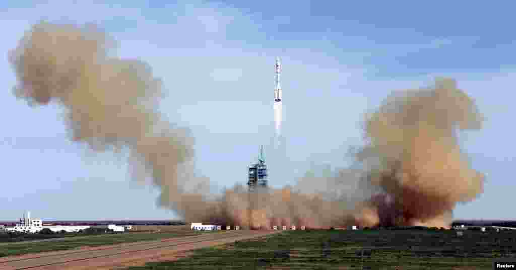 China's Long March 2-F rocket blasts off with three astronauts onboard for a 15-day mission to an experimental space lab in the latest step toward the development of a Chinese space station. (Reuters)