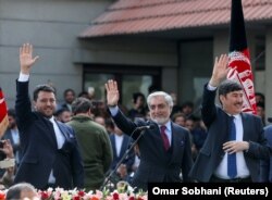 Abdullah Abdullah (center) gestures to his supporters after his own swearing-in ceremony in Kabul on March 9.