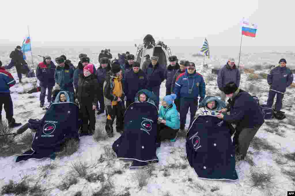 Cosmonauts Yelena Serova (left) and Aleksandr Samokutayev and NASA astronaut Barry Wilmore (right) sit in chairs outside their Soyuz TMA-14M spacecraft just minutes after they landed in a remote area near the town of Zhezkazgan, Kazakhstan, on March 12. They spent almost six months on the International Space Station. (AFP/Bill Ingalls)