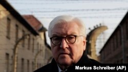 Germany's President Frank-Walter Steinmeier talks to journalists after laying a wreath at the Death Wall at the Auschwitz I Nazi death camp in Oswiecim, Poland, Monday, Jan. 27, 2020. 