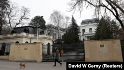 A man walks his dog past the Russian Embassy in Prague on Pod Kastany Square, which could be officially renamed on February 27 -- the fifth anniversary of Boris Nemtsov's killing. (file photo)