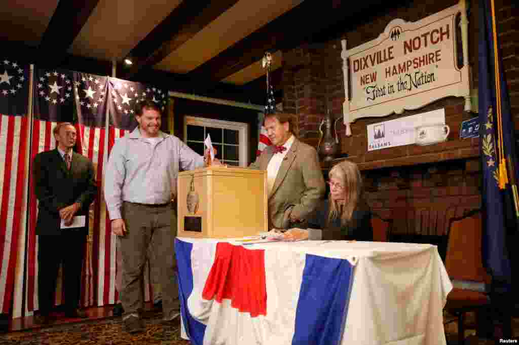 At midnight, in the tiny New Hampshire town of Dixville Notch, Clay Smith is the first to cast his ballot in the U.S. presidential election.