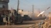 Iraqi forces launch a rocket in Mosul's eastern Al-Intisar neighborhood late last week. Officials say it could be months before government forces are able to completely retake the country's second-largest city from Islamic State militants. 