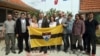 Vit Jedlicka (center) poses with the Liberland flag and future citizens in a Serbian village in 2015.