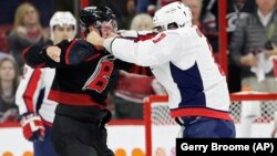 The Washington Capitals' Alex Ovechkin (right) punches the Carolina Hurricanes' Andrei Svechnikov during the first period on April 15.