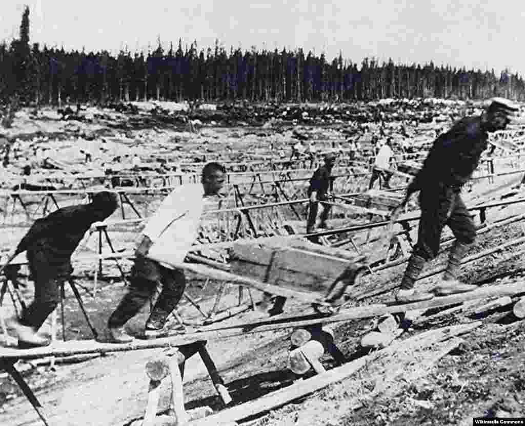 Laborers excavate the canal site.