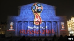 A light installation shows the official logotype of the 2018 FIFA World Cup during its unveiling ceremony at the Bolshoi Theater building in Moscow in October 2014.