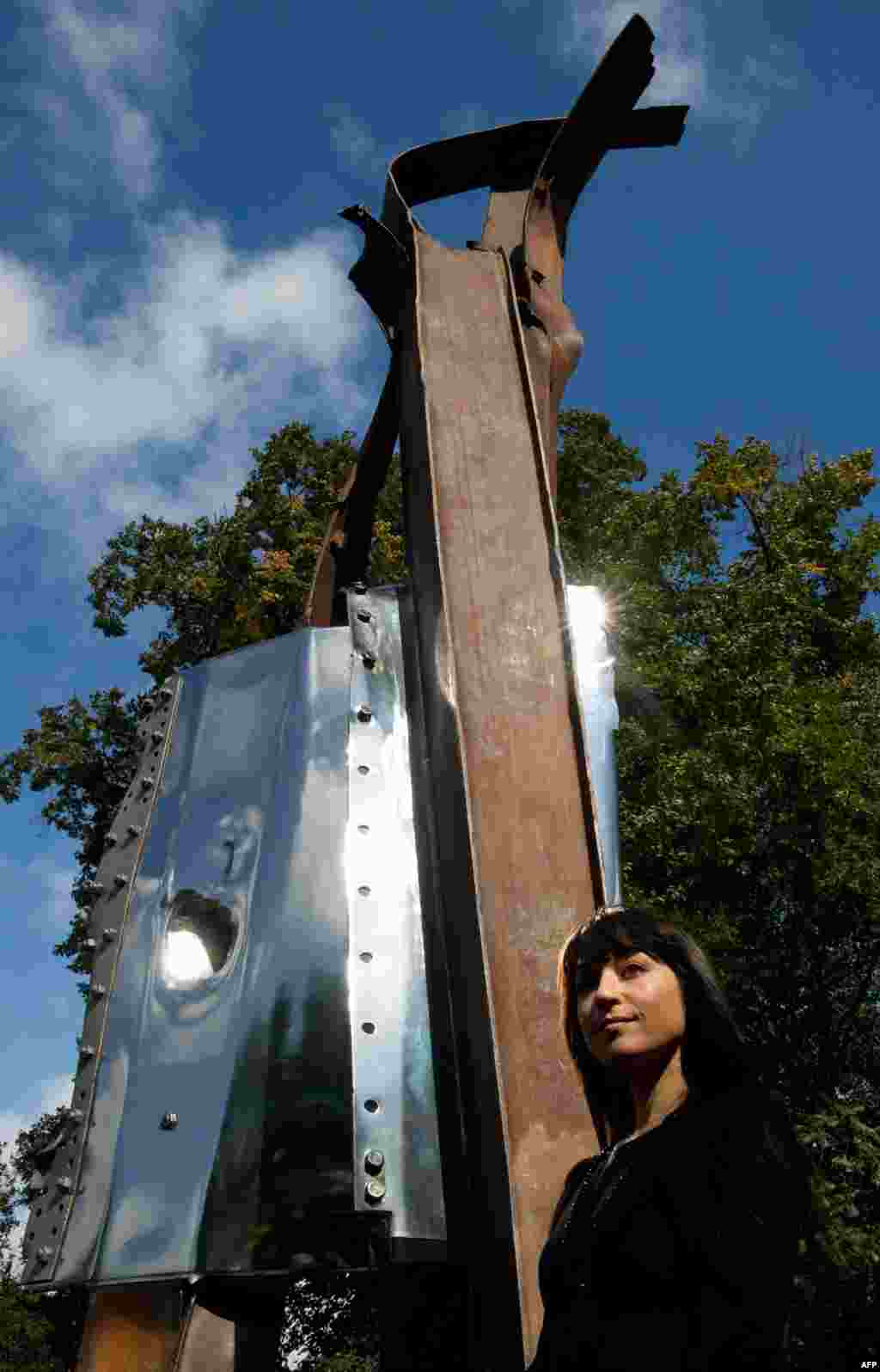 U.S. artist Miya Ando poses in London next to her work, After 9/11, made from steel recovered from the World Trade Center. The sculpture was moved from its temporary location in Battersea Park to London&#39;s Olympic Park after a long delay in designating a permanent home. It was a gift from the Port Authority of New York and New Jersey to the United Kingdom.&nbsp;