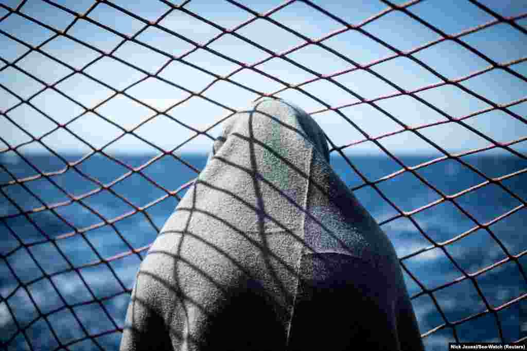 A migrant looks out at the water on board the Sea Watch 3 German charity ship, off the coast of Lampedusa, Italy, on May 19. (Nick Jaussi via Reuters)