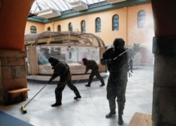 Spanish soldiers disinfect a marketplace in Pamplona on April 8, 2020.