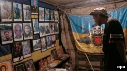 Ukrayna döyüşçüsü Avdiyivka cəbhəsində həlak olmuş yoldaşlarının şəkillərinə baxır