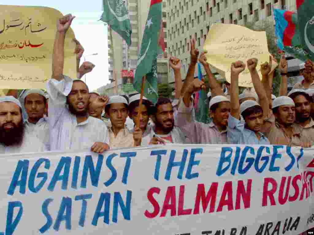 Jamiat Talba-e Arabiya supporters in Karachi, Pakistan, hold signs targeting Rushdie during a protest days after the author was awarded Knight Bachelorship.