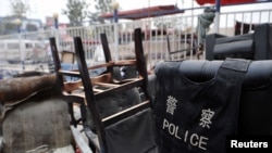 Destroyed furniture is stacked outside a police station after a July 18 clash in Hotan, in China's Xinjiang Uyghur Autonomous Region.