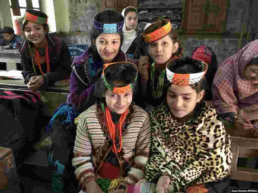 Kalash schoolkids cluster in front of the camera. The Kalash are part of a wider ethnic group that once stretched into neighboring Afghanistan.
