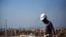 Iran -- An Iranian worker walks near the phase 12 of the South Pars gas field facilities near the southern town of Kangan on the shore of the Gulf on January 22, 2014. South Pars, a huge offshore natural gas field shared between Iran and Qatar, holds arou