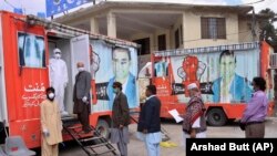 People wait for their turn to get free chest X-rays and other tests during a nationwide lockdown to help avoid the spread of the coronavirus, in Quetta.