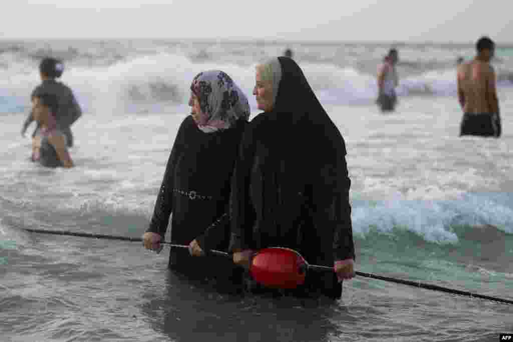 Palestinians enjoy the beach in Tel Aviv. Tens of thousands of Palestinians have visited Tel Aviv and other places in Israel after Israel granted travel permits to West Bank Palestinians. (AFP/Menahem Kahana)