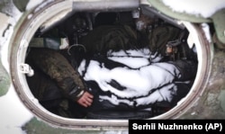 The dead bodies of Russian soldiers are seen in military vehicle on a road in the town of Bucha, close to the capital, Kyiv.