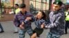 Kazakh law enforcement officers detain a woman during a protest rally by opposition supporters in Nur-Sultan on September 21. (RFE/RL / Orken Zhoyamergen)