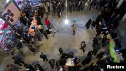 Men and women wait in separate lines in a mosque in south Tehran on March 2 to vote in the Iranian parliamentary elections.