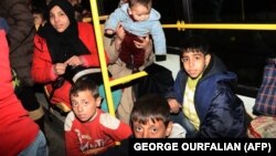 Syrian families from various eastern districts of Aleppo are evacuated by bus on November 27 as Syrian pro-government forces continued their advance toward rebel-controlled districts. 