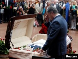 Ukrainian President Petro Poroshenko reflects at the coffin of journalist Pavel Sheremet, who was killed by a car bomb on July 20 in Kyiv. While condemning attacks on journalists, Poroshenko has also said journalists should not write "negative articles" about Ukraine.