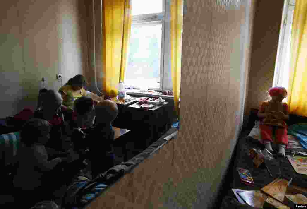 Children of families who have fled from fighting in Slovyansk play with toys at temporary accommodation in a dormitory in the town of Ilovaysk on June 3.