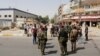 Iraqi security forces gather at the site of a suicide bomb blast in Baghdad al-Jadida on September 27.