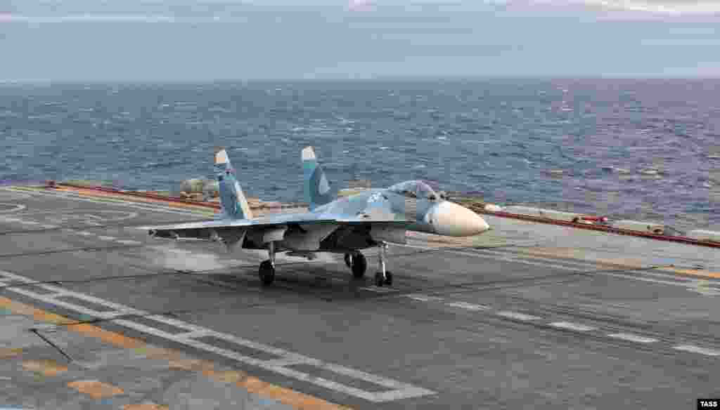 A Sukhoi fighter landing on the deck of the Admiral Kuznetsov. In 2005, a fighter jet plummeted off the end of the carrier after an arresting cable snapped on landing. Both pilots escaped, but the plane plunged into 1-kilometer-deep water.