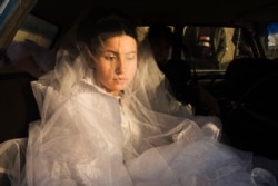 A teenage bride appears deep in thought on her wedding day in 2010.