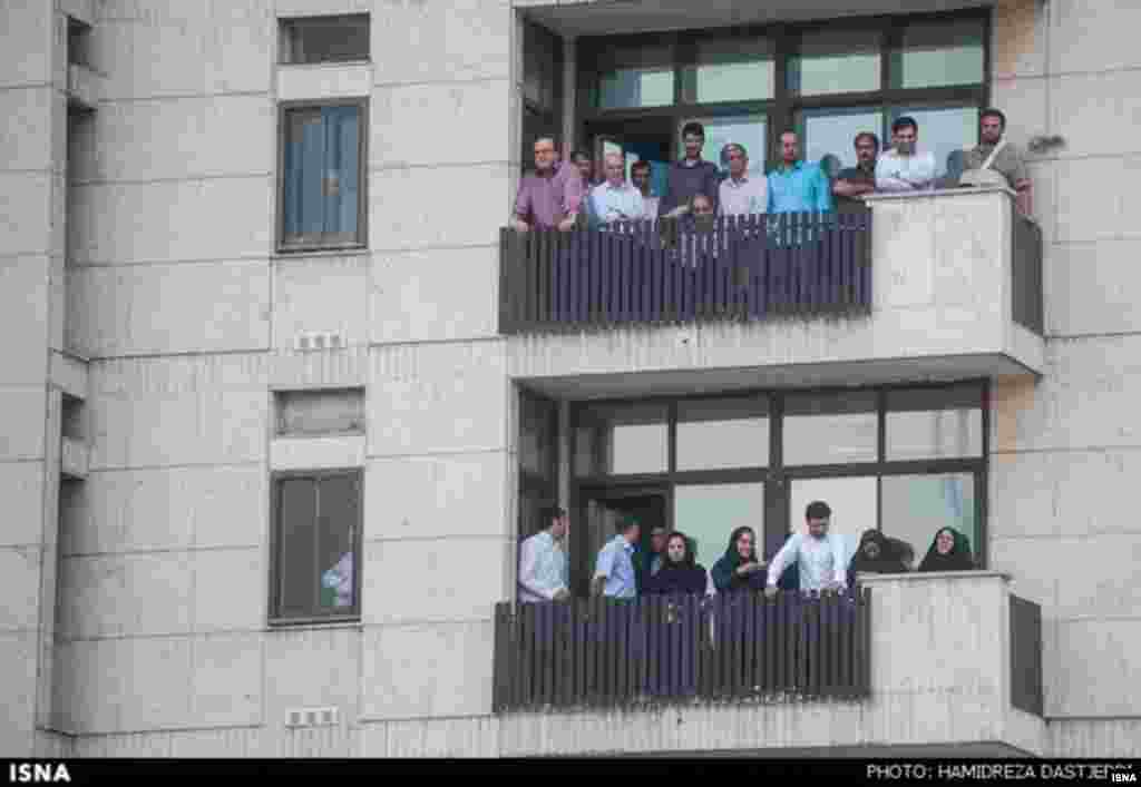 Neighbors watch as the drama unfolds.