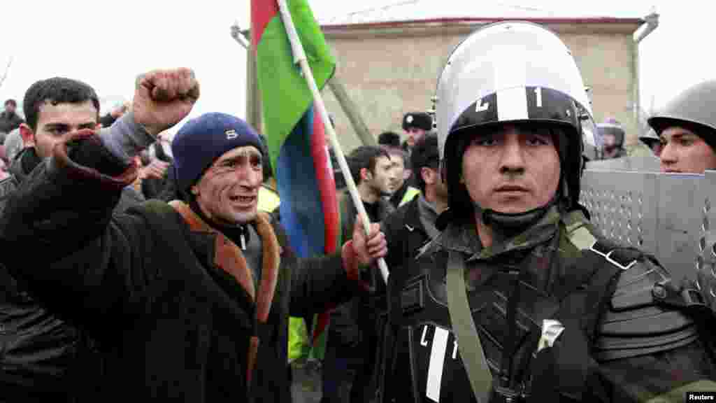 A protester shouts at a policeman during a demonstration in the central square of Quba, Azerbaijan, before a breakout of violence on March 1. (Reuters/Abbas Atilay)