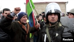 A protester shouts at a policeman during a demonstration in the central square of Quba on March 1.