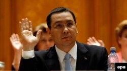 Romanian Prime Minister Victor Ponta votes at the opening of a no-confidence motion in front of the parliament in Bucharest on June 12.