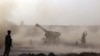 Iraqi Shi'ite fighters from a Popular Mobilization unit use mobile artillery near the city of Fallujah as part of an assault aimed at taking back the city of Fallujah from Islamic State. 