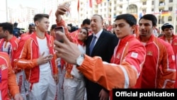 Azerbaijani President Ilham Aliyev poses for a few selfies as he meets with European Games athletes in Baku.