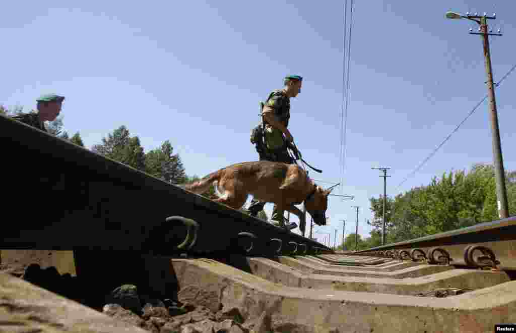 Border guards cross the railways near the Belarus-Poland border on the outskirts of the western city of Brest.