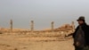 A soldier looks at ruins left by Islamic State militants in Nimrud shortly after Iraqi forces retook the ancient city on November 13. Nimrud is some 30 kilometers south of Mosul, which remains partly under militant control.&nbsp;