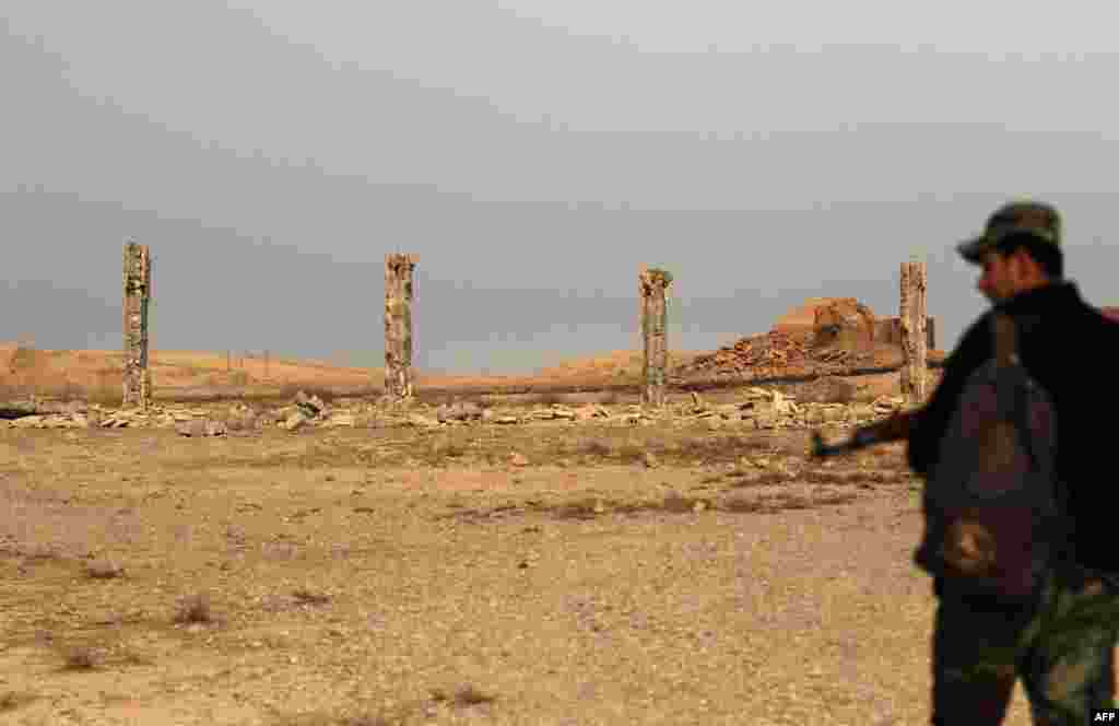 A soldier looks at ruins left by Islamic State militants in Nimrud shortly after Iraqi forces retook the ancient city on November 13. Nimrud is some 30 kilometers south of Mosul, which remains partly under militant control.&nbsp;