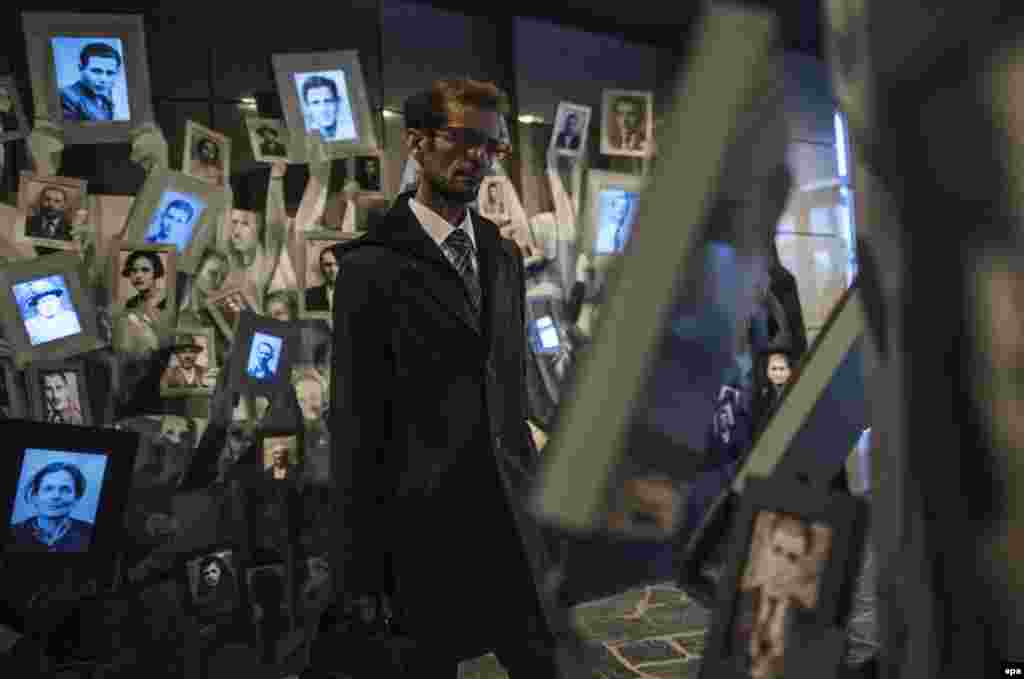 A man reviews portraits of victims of the Holocaust in the Holocaust Memorial Center for the Jews of Macedonia in Skopje on April 24. (epa/Georgi Licovski)